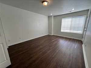 Unfurnished room with dark hardwood / wood-style flooring