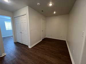 Spare room with dark wood-type flooring