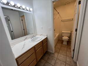 Full bathroom featuring tile patterned floors, shower / washtub combination, vanity, and toilet