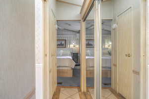 Interior space featuring lofted ceiling and light tile patterned floors