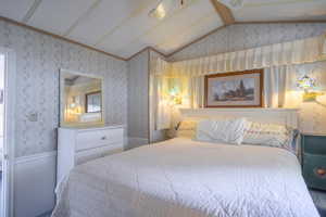 Bedroom featuring lofted ceiling with beams