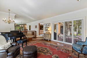 Living room with ornamental molding and an inviting chandelier