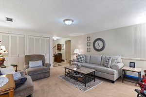 Living room featuring light carpet