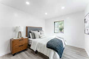 Bedroom with light hardwood / wood-style floors