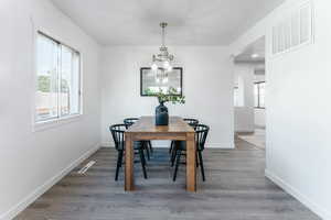 Dining room featuring a chandelier and hardwood / wood-style flooring