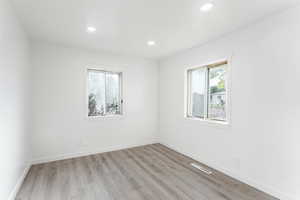 Unfurnished room with light hardwood / wood-style flooring