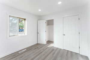 Unfurnished bedroom featuring light wood-type flooring