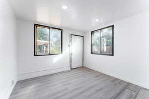 Spare room featuring light hardwood / wood-style flooring and a textured ceiling