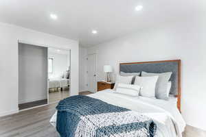 Bedroom featuring wood-type flooring and a closet