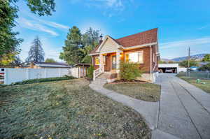 View of front facade featuring a porch, a front yard, and a mountain view