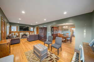 Living room featuring an inviting chandelier and light hardwood / wood-style flooring