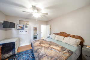 Bedroom featuring ceiling fan and wood-type flooring