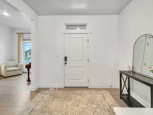 Foyer entrance featuring wood-type flooring