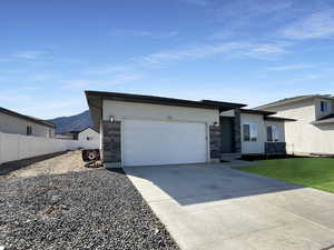 View of front facade with a garage and a mountain view