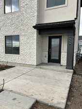 Entrance to property with stucco siding