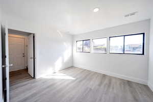 Unfurnished room featuring light wood-type flooring