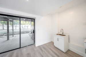 Interior space with light hardwood / wood-style floors and sink