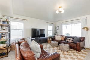 Living room with light carpet and a healthy amount of sunlight