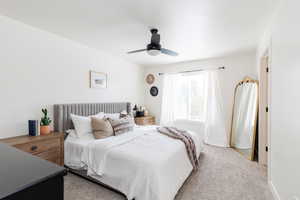 Bedroom with light carpet and ceiling fan