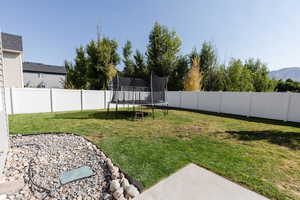 View of yard with a mountain view and a trampoline