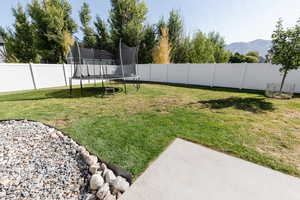 View of yard featuring a mountain view and a trampoline