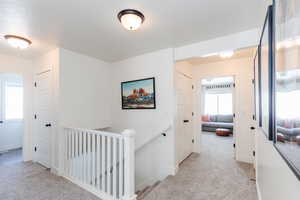 Corridor with light colored carpet