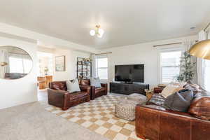 Carpeted living room with a healthy amount of sunlight