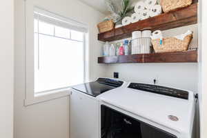 Clothes washing area featuring independent washer and dryer