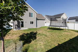 View of yard featuring a trampoline and a patio area