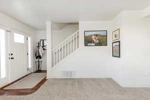 Foyer with dark carpet