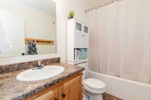 Full bathroom with vanity, toilet, and shower / tub combo with curtain