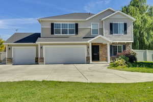 View of front of house featuring a garage and a front lawn