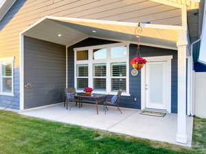 Back door to covered patio and privacy fenced backyard