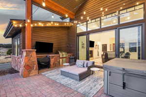 Patio terrace at dusk featuring grilling area