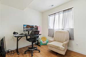 Office featuring hardwood / wood-style floors