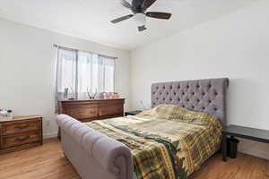 Bedroom featuring light hardwood / wood-style flooring and ceiling fan