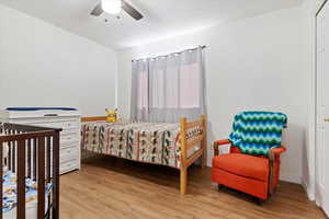 Bedroom featuring ceiling fan and light hardwood / wood-style flooring