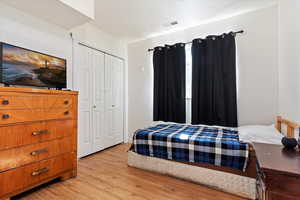 Bedroom featuring a closet and light hardwood / wood-style flooring