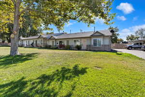 Single story home with a front lawn