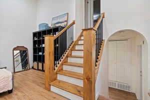 Stairs with hardwood / wood-style floors