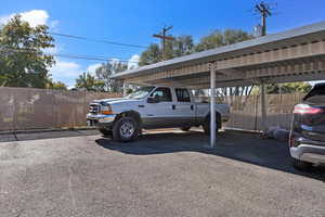 View of car parking featuring a carport