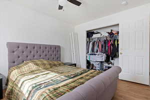 Bedroom featuring a closet, light hardwood / wood-style floors, and ceiling fan