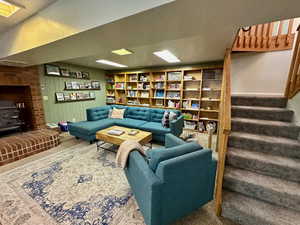 Carpeted living room featuring a wood stove