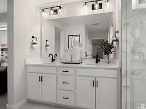 Bathroom featuring walk in shower and vanity