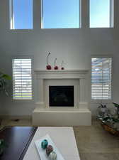 Unfurnished living room featuring hardwood / wood-style floors and a high ceiling