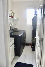 Laundry area with washer and dryer and cabinets