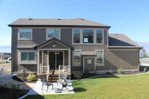 Back of property with a yard and a patio