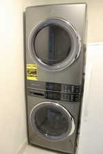 Laundry room featuring stacked washer / dryer