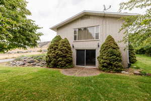 Rear view of house featuring a yard