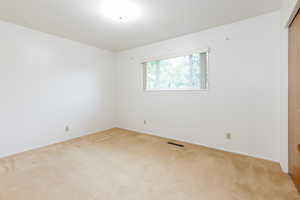 Spare room featuring light colored carpet